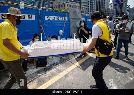 Members of the Sewol victims' council move some Sewol ferry art works ...