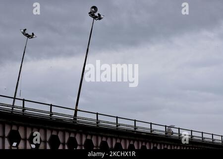 Commuters walk over a brigde during Rainfall in Sopore, District Baramulla Jammu And Kashmir, India on 28 July 2021. 4 dead, 36 missing after cloud burst at Jammu and Kashmir's Kishtwar Four persons were killed and around 36 others are missing and feared dead in a cloud burst in Kistwar district, officials said. Reports reaching said that the cloud burst hit Honjar Dacchan, sweeping away six houses and a ration depot. (Photo by Nasir Kachroo/NurPhoto) Stock Photo