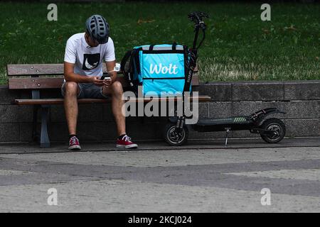 Wolt courier with an electric scooter is seen in Vilnius, Lithuania on July 27, 2021. (Photo by Jakub Porzycki/NurPhoto) Stock Photo