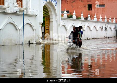 Indian People cross a Flooded street after heavy Monsoon Rains in ...