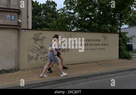 Two young women walk past a mural commemorating the Primate of Poland, Cardinal Stefan Wyszynski, seen in Lublin center. Cardinal Wyszynski was scheduled to be beatified in Warsaw on 7 June 2020 but the beatification was delayed due to the COVID-19 pandemic and rescheduled to 12 September 2021. On Saturday, July 31, 2021, in Lublin, Lublin Voivodeship, Poland. (Photo by Artur Widak/NurPhoto) Stock Photo