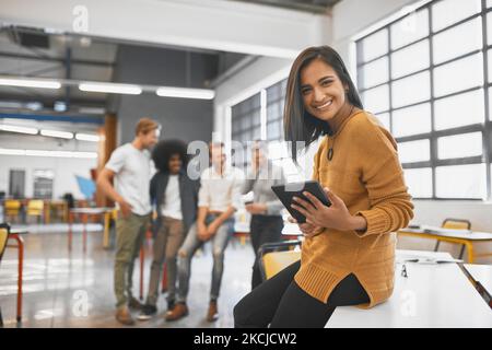 Ive got something big on the way. Cropped portrait of an attractive young businesswoman in the office with his colleagues in the background. Stock Photo