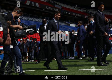 Paris Saint-Germain's Qatari President Nasser Al-Khelaifi (L) and Paris Saint-Germain's Sporting Director Leonardo Nascimento de Araujo (R) pose along side Argentinian football player Lionel Messi (C) as he holds-up his number 30 shirt during a press conference at the French football club Paris Saint-Germain's (PSG) Parc des Princes stadium in Paris on August 11, 2021. The 34-year-old superstar signed a two-year deal with PSG on August 10, 2021, with the option of an additional year, he will wear the number 30 in Paris, the number he had when he began his professional career at Spain's Barca f Stock Photo