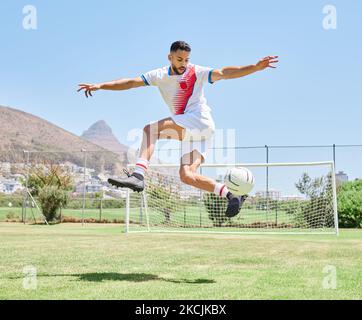 Soccer player field, man soccer ball trick and control outdoor on grass for sports, fitness and health. Jump football skill, young sport athlete and Stock Photo