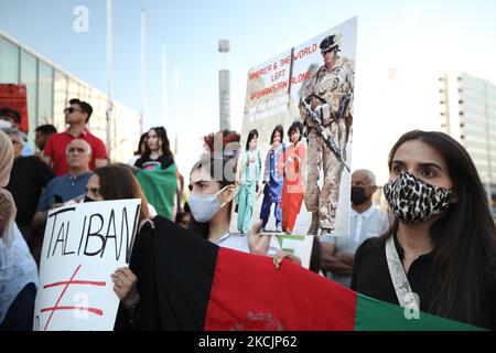 Dozens of Afghan gathered for a rally in solidarity with their countrymen on Sunday, on August 15, 2021 to condemn the actions of the Taliban, who have taken control of Afghanistan. Waving Afghan flags and holding up signs that read 'Save Afghanistan,' 'Help My Friend & Family #Afghanistan,' and 'Stop War in Afghanistan,' hundreds showed up at Celebration Square to denounce the takeover and call on the international community to do more to help Afghanistan. (Photo by Sayed Najafizada/NurPhoto) Stock Photo