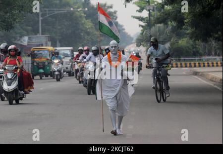 A man dressed as like as father of nation mahatma Gandhi as he is seen on the road and returns back home after attaining the 75th Independence Day celebration event in the eastern Indian state Odisha's capital city Bhubaneswar on August, 15, 2021. (Photo by STR/NurPhoto) Stock Photo