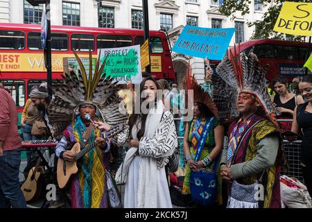 LONDON, UNITED KINGDOM - AUGUST 25, 2021: Activists and campaigners joined by indigenous people from Brazil protest near Brazilian Embassy in solidarity with the Indigenous peoples of Brazil as the Bolsonaro's government attempts to further open up Indigenous lands to mining and other commercial activities that could exacerbate the destruction of the Amazon rainforest on 25 August 2021 in London, England. The protesters demonstrate against Congressional bill 490/2007, which would prevent Indigenous peoples from obtaining legal recognition of their traditional lands if they were not present the Stock Photo
