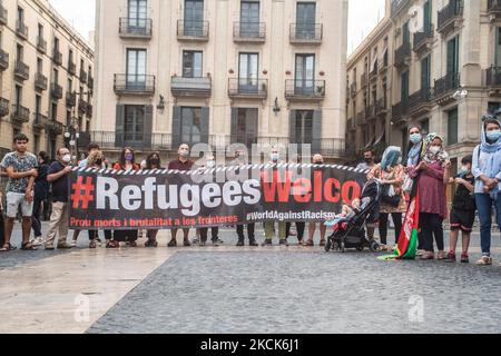 Protesters are seen holding a sign that says, refugees welcome. The Afghan association of Barcelona has demonstrated in front of the Generalitat of Catalonia to ask the government for the protection and evacuation of their families who have remained in Afghanistan. (Photo by DAX Images/NurPhoto) Stock Photo