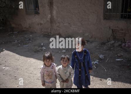 Afghan refugee children Sakineh (R), Hares (C) and Leili who have escaped from their hometown city of Herat with their parents to Iran about three months ago while they feared the Taliban possible victory over the Afghan Government, look on as they pose for a photograph in front of a home in an area in the south of Tehran, August 27, 2021. The Taliban seized power in Afghanistan on August 15, 2021, twenty years after the U.S. and International Coalition Forces have been attacked against the Osama bin Laden, who was a founder of al-Qaeda. (Photo by Morteza Nikoubazl/NurPhoto) Stock Photo