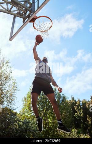 Basketball, black man and shooting, athlete and fitness, playing sports on outdoor basketball court and jumping. Active, exercise and sport with Stock Photo
