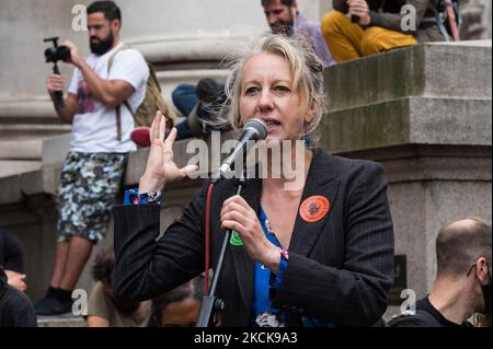 LONDON, UNITED KINGDOM - AUGUST 27, 2021: Extinction Rebellion co-founder Dr Gail Bradbrook addresses activists from Extinction Rebellion gathered outside Bank of England ahead of a march through the City of London in a protest against the companies and institutions that are financing, insuring and enabling major fossil fuel projects and extraction of resources in the developing countries of the Global South, demanding change to the colonial system that drives the crises of climate and racism on 27 August 2021 in London, England. Extinction Rebellion activists target the City of London during  Stock Photo