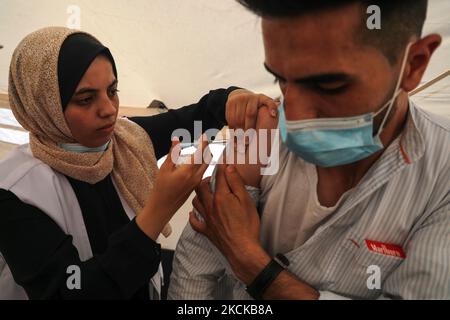 A Palestinian man receives a dose of the Sputnik-V Covid-19 vaccine during a vaccination campaign by the health ministry in Gaza City , on August 27, 2021. (Photo by Majdi Fathi/NurPhoto) Stock Photo