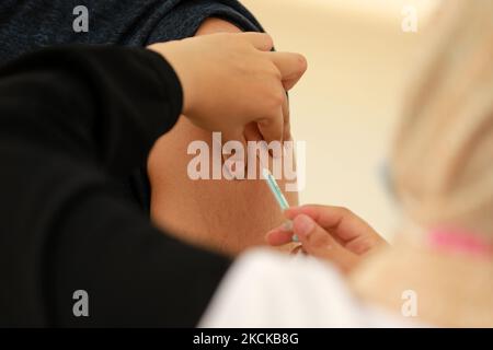 A Palestinian man receives a dose of the Sputnik-V Covid-19 vaccine during a vaccination campaign by the health ministry in Gaza City , on August 27, 2021. (Photo by Majdi Fathi/NurPhoto) Stock Photo