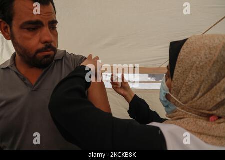 A Palestinian man receives a dose of the Sputnik-V Covid-19 vaccine during a vaccination campaign by the health ministry in Gaza City , on August 27, 2021. (Photo by Majdi Fathi/NurPhoto) Stock Photo