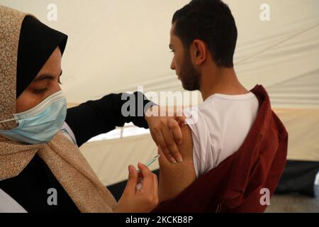 A Palestinian man receives a dose of the Sputnik-V Covid-19 vaccine during a vaccination campaign by the health ministry in Gaza City , on August 27, 2021. (Photo by Majdi Fathi/NurPhoto) Stock Photo