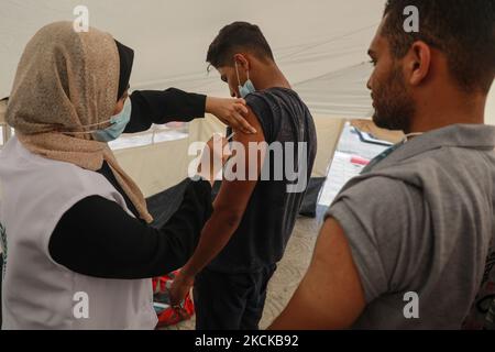 A Palestinian man receives a dose of the Sputnik-V Covid-19 vaccine during a vaccination campaign by the health ministry in Gaza City , on August 27, 2021. (Photo by Majdi Fathi/NurPhoto) Stock Photo