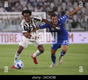 Juan Cuadrado (L) of Juventus competes for the ball with Filippo Bandinelli (R) of Empoli FC during the Serie A match between Juventus and Empoli FC at Allianz Stadium on August 28, 2021 in Turin, Italy. (Photo by Giuseppe Cottini/NurPhoto) Stock Photo