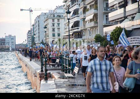 Thousands of protesters at the seafront of Thessaloniki holding Greek flags and banners marching during the protests. Multiple protests with thousands of demonstrators participating took place in Thessaloniki city. The demonstration was against the mandatory COVID-19 vaccination measure of the public healthcare workers, doctors, teachers to fight the pandemic as from September 1, 2021 unvaccinated government employees in the health sector will be suspended. Thousands of protesters arrived from northern Greece which marched in the city center for hours, following speeches. Among the protesters  Stock Photo