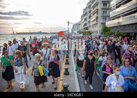 Thousands of protesters at the seafront of Thessaloniki holding Greek flags and banners marching during the protests. Multiple protests with thousands of demonstrators participating took place in Thessaloniki city. The demonstration was against the mandatory COVID-19 vaccination measure of the public healthcare workers, doctors, teachers to fight the pandemic as from September 1, 2021 unvaccinated government employees in the health sector will be suspended. Thousands of protesters arrived from northern Greece which marched in the city center for hours, following speeches. Among the protesters  Stock Photo