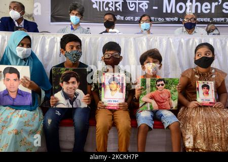 A group of children hold portraits of their missing family members at an event organized the Mother's Call a platform of the victims of enforced disappearance on the International Day of the Victims of Enforced Disappearances in Dhaka, Bangladesh, August 30, 2021. (Photo by Mamunur Rashid/NurPhoto) Stock Photo