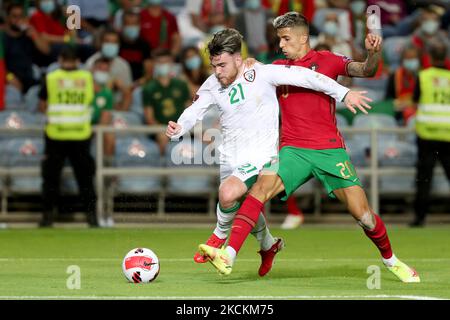 Republic of Ireland's forward Aaron Connolly (L) vies with Portugal's defender Joao Cancelo during the FIFA World Cup 2022 European qualifying round group A football match between Portugal and Republic of Ireland, at the Algarve stadium in Faro, Portugal, on September 1, 2021. (Photo by Pedro FiÃºza/NurPhoto) Stock Photo