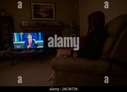 A woman watches Liberal Party of Canada Leader Justin Trudeau speaking during the official televised Federal election leaders' debate at her home in Edmonton. Five federal leaders take part in the English-language debate with Bloc Québécois Leader Yves-François Blanchet, Conservative Party of Canada Leader Erin O’Toole, Green Party of Canada Leader Annamie Paul, Liberal Party of Canada Leader Justin Trudeau and New Democratic Party Leader Jagmeet Singh. On Thursday, 9 September 2021, in Edmonton, Alberta, Canada. (Photo by Artur Widak/NurPhoto) Stock Photo