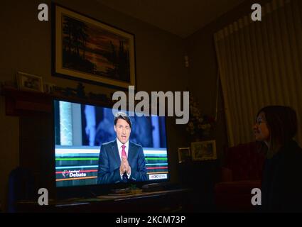 A woman watches Liberal Party of Canada Leader Justin Trudeau speaking during the official televised Federal election leaders' debate at her home in Edmonton. Five federal leaders take part in the English-language debate with Bloc Québécois Leader Yves-François Blanchet, Conservative Party of Canada Leader Erin O’Toole, Green Party of Canada Leader Annamie Paul, Liberal Party of Canada Leader Justin Trudeau and New Democratic Party Leader Jagmeet Singh. On Thursday, 9 September 2021, in Edmonton, Alberta, Canada. (Photo by Artur Widak/NurPhoto) Stock Photo