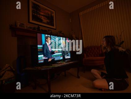 A woman watches the official televised Federal election leaders' debate at her home in Edmonton. Five federal leaders take part in the English-language debate with Bloc Québécois Leader Yves-François Blanchet, Conservative Party of Canada Leader Erin O’Toole, Green Party of Canada Leader Annamie Paul, Liberal Party of Canada Leader Justin Trudeau and New Democratic Party Leader Jagmeet Singh. On Thursday, 9 September 2021, in Edmonton, Alberta, Canada. (Photo by Artur Widak/NurPhoto) Stock Photo