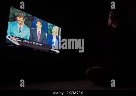 A woman watches the official televised Federal election leaders' debate at her home in Edmonton. Five federal leaders take part in the English-language debate with Bloc Québécois Leader Yves-François Blanchet, Conservative Party of Canada Leader Erin O’Toole, Green Party of Canada Leader Annamie Paul, Liberal Party of Canada Leader Justin Trudeau and New Democratic Party Leader Jagmeet Singh. On Thursday, 9 September 2021, in Edmonton, Alberta, Canada. (Photo by Artur Widak/NurPhoto) Stock Photo