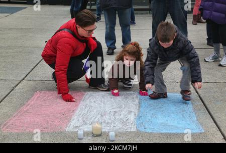 November 14, 2015, Toronto, Ontario, Canada --- Canadians place candles and flowers by a French flag during a vigil at Nathan Phillips Square in Toronto, Canada to show solidarity with the citizens of France a day after the Paris terrorist attacks. Islamic State jihadists claimed a series of coordinated attacks by gunmen and suicide bombers in Paris on November 13 that killed at least 129 people and injured more than 350 in scenes of carnage at a concert hall, restaurants and the national stadium. This attack is the deadliest attack in Paris since the Second World War. --- (Photo by Creative T Stock Photo