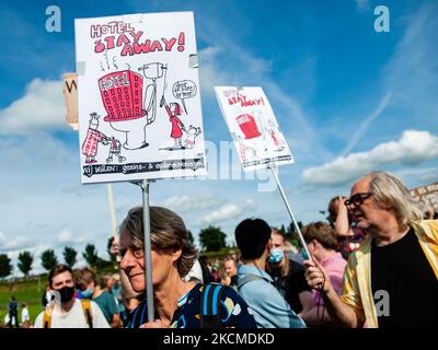 A woman is holding a placard against the hotels, during the demonstration for the right to decent housing organized, in Amsterdam, on September 12th, 2021. (Photo by Romy Arroyo Fernandez/NurPhoto) Stock Photo