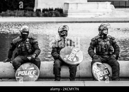 Arlington County Police officers in riot gear take a rest on a hot day during the Justice for J6 rally hosted by Look Ahead America at the US Capitol. Arlington is one of many jurisdictions that are contributing personnel to protect the Capitol under mutual assistance agreements with the Capitol Police. The purpose of the rally is to protest detention of what they falsely claim are political prisoners - non-violent protesters charged with crimes committed during the January 6 insurrection. In addition to the event at the Capitol, rallies are taking place in 17 state capitals. (Photo by Allison Stock Photo