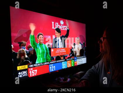 A woman watches Liberal Party of Canada Leader Justin Trudeau celebrating with his family during a televised election night on CTV News. Early election results predict Liberal leader Justin Trudeau to win enough seats in this 44th general election to form another minority government On Monday, September 20, 2021, in Edmonton, Alberta, Canada. (Photo by Artur Widak/NurPhoto) Stock Photo