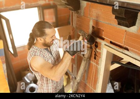Strong man making a groove to put wiring Stock Photo