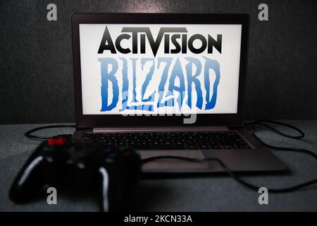 Activision Blizzard logo displayed on a laptop screen and a gamepad are seen in this illustration photo taken in Krakow, Poland on September 21, 2021. (Photo by Jakub Porzycki/NurPhoto) Stock Photo