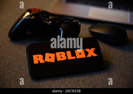 Roblox logo displayed on a phone screen, a gamepad and a computer mouse are seen in this illustration photo taken in Krakow, Poland on September 21, 2021. (Photo by Jakub Porzycki/NurPhoto) Stock Photo