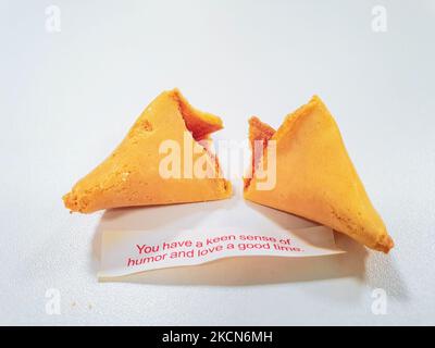 Broken fortune cookie with a positive vibe message under it and copy space around. Stock Photo