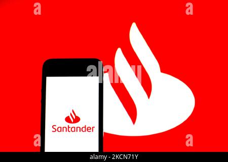 In this photo illustration a Banco Santander, S.A. logo seen displayed on a smartphone with a Banco Santander, S.A. logo in the background. (Photo by DAX Images/NurPhoto) Stock Photo