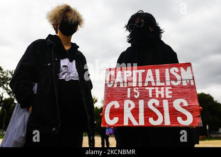 A woman holds a banner 'Capitalism Is the Crisis' during Climate Strike protest organized by Fridays for Future movement also known as Youth Strike for Climate. Krakow, Poland on September 24, 2021. Participants, who wore face masks due to the coronavirus pandemic, demonstrated demanding action from political leaders to prevent climate change and for the fossil fuel industry to transition to renewable energy. (Photo by Beata Zawrzel/NurPhoto) Stock Photo