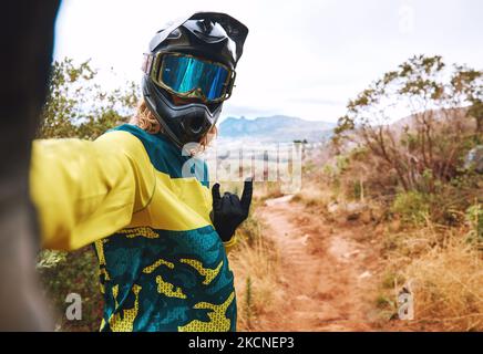 Sports, biker selfie and cycling in nature, countryside or outdoors. Bmx, rock hand sign or self portrait of cyclist on sand or dirt road for Stock Photo
