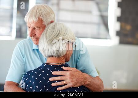 Life is better with a shoulder to cry on. a senior man embracing his wife. Stock Photo