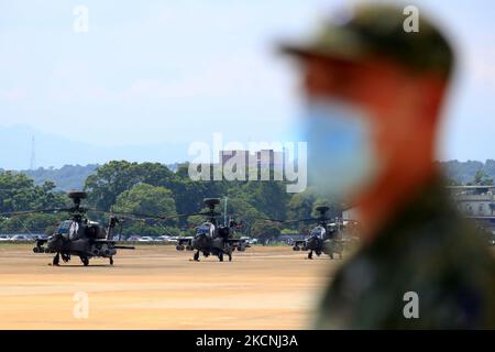 Military helicopters are on standby at a military camp, as part of a rehearsal for the flyby performance for Taiwan’s Double-Ten National Day Celebration, amid rising tensions between Beijing and Taipei and threats from China, in Taoyuan, Taiwan, 28 September 2021. The 18-meter wide and 12-meter long Taiwan flag, according to state media Central News Agency, will be carried by two CH-47 Chinook helicopters flag flying over the Presidential Office, in addition to a parade displaying the island’s missile systems which will showcase the armed forces' ability to resist threats from China. (Photo b Stock Photo