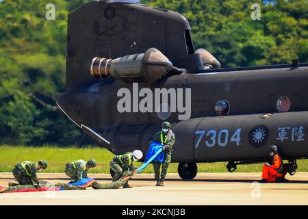 Military officers hang the biggest Taiwan flag ever on a chinook Helicopter at a military camp, as part of a rehearsal for the flyby performance for Taiwan’s Double-Ten National Day Celebration, amid rising tensions between Beijing and Taipei and threats from China, in Taoyuan, Taiwan, 28 September 2021. The 18-meter wide and 12-meter long Taiwan flag, according to state media Central News Agency, will be carried by two CH-47 Chinook helicopters flag flying over the Presidential Office, in addition to a parade displaying the island’s missile systems which will showcase the armed forces' abilit Stock Photo