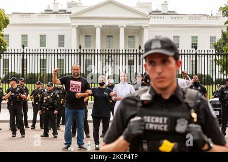 Voting rights activists Ben Jealous (left), Noelle Damico (center), and Sister Quincy Howard (right) await arrest at the White House, demanding that the Biden Administration take the lead on voting rights and pressure Congress to pass legislation protecting the right to vote. (Photo by Allison Bailey/NurPhoto) Stock Photo