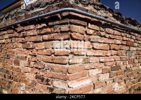 Corner  of a brick wall with piping on it Stock Photo