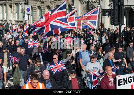 LONDON, UNITED KINGDOM - OCTOBER 09, 2021: Northern Ireland unionists and loyalists march along Whitehall in a protest against the Northern Ireland Protocol, which they argue undermines Northern Ireland's position as part of the United Kingdom by creating a trade border on the Irish Sea on October 09, 2021 in London, England. Next week, the EU is set to bring forward new proposals for the Northern Ireland Protocol, which was implemented after Brexit to protect the Good Friday agreement by keeping Northern Ireland aligned with the EU's single market for goods to prevent creating a hard border o Stock Photo