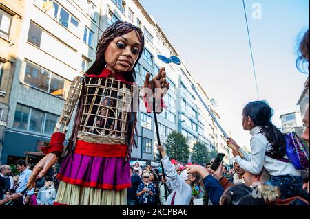 A giant puppet is currently grabbing attention across Europe to the plight of young refugees who have fled from Syria. Little Amal represents a nine-year-old Syrian refugee girl and is over 11-feet-tall. She has been walking nearly 8,000 km from the Syrian-Turkish border looking for her mother and it will end in November in Manchester. This weekend, Amal, which means “hope” in Arabic, was warmly welcomed by children, musicians, and other giants to the Borgerhout district known for its cultural diversity, on October 9th, 2021. (Photo by Romy Arroyo Fernandez/NurPhoto) Stock Photo