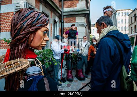 A giant puppet is currently grabbing attention across Europe to the plight of young refugees who have fled from Syria. Little Amal represents a nine-year-old Syrian refugee girl and is over 11-feet-tall. She has been walking nearly 8,000 km from the Syrian-Turkish border looking for her mother and it will end in November in Manchester. This weekend, Amal, which means “hope” in Arabic, was warmly welcomed by children, musicians, and other giants to the Borgerhout district known for its cultural diversity, on October 9th, 2021. (Photo by Romy Arroyo Fernandez/NurPhoto) Stock Photo