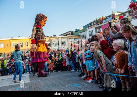 A giant puppet is currently grabbing attention across Europe to the plight of young refugees who have fled from Syria. Little Amal represents a nine-year-old Syrian refugee girl and is over 11-feet-tall. She has been walking nearly 8,000 km from the Syrian-Turkish border looking for her mother and it will end in November in Manchester. This weekend, Amal, which means “hope” in Arabic, was warmly welcomed by children, musicians, and other giants to the Borgerhout district known for its cultural diversity, on October 9th, 2021. (Photo by Romy Arroyo Fernandez/NurPhoto) Stock Photo