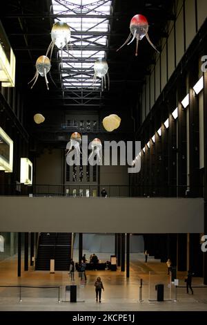 Helium-filled, rotor-propelled 'aerobes' forming artist Anicka Yi's 'In Love With The World' float around the Turbine Hall of the Tate Modern art gallery at the unveiling of the work, the latest in the Hyundai Commission series, in London, England, on October 11, 2021. The floating machines are intended to 'prompt viewers to think about new ways that machines might inhabit the world', and form the sixth Hyundai Commission of annual works created by artists specially for the Turbine Hall. The installation will run until January 16 next year. (Photo by David Cliff/NurPhoto) Stock Photo